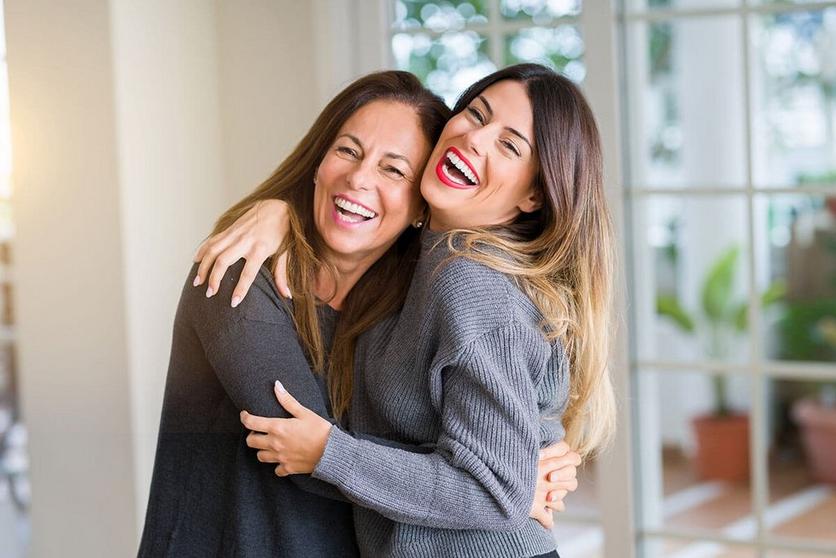 Mother-And-Daughter-Hugging-Lauging