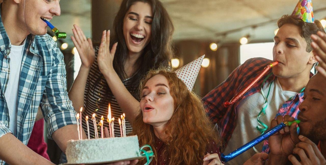 woman-blowing-candles-on-a-cake-out