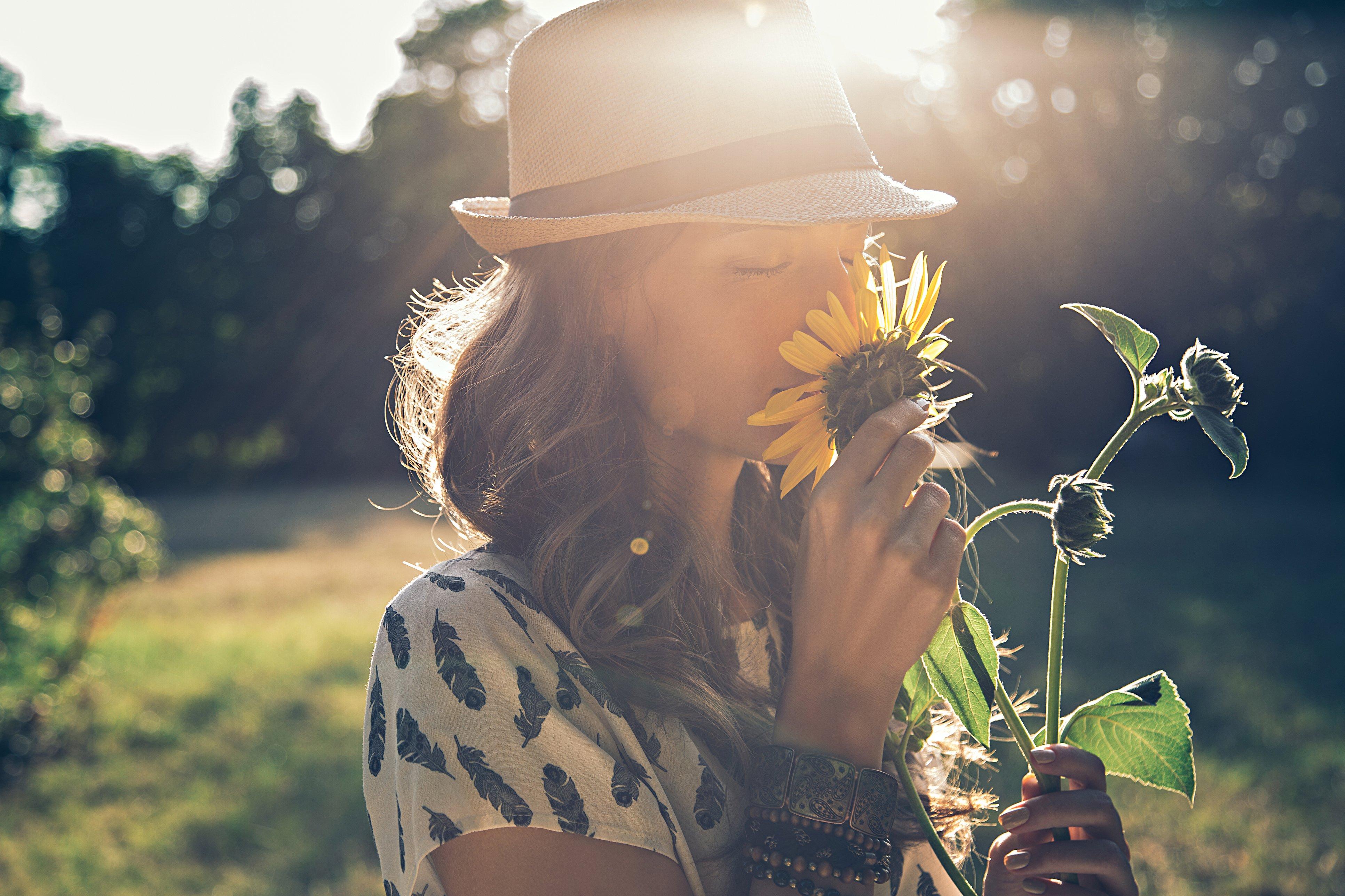 woman-sunflowers-smell-sun
